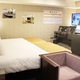 The train simulator is located directly in front of the bed.